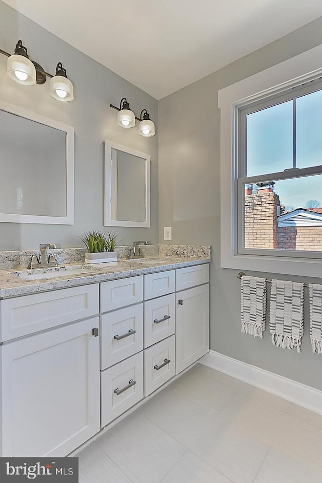 bathroom featuring tile patterned flooring and vanity