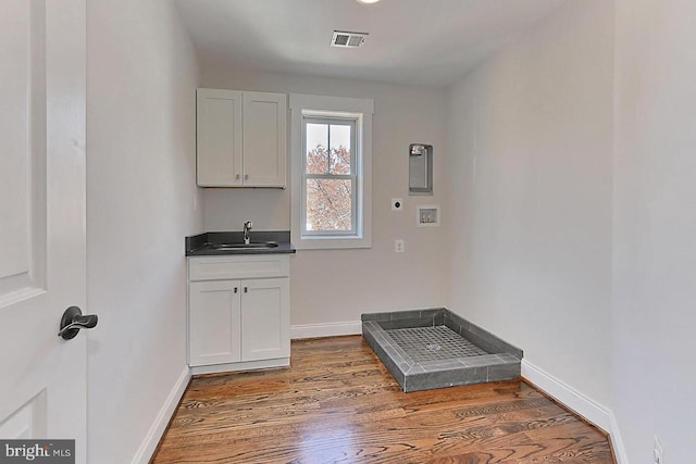 washroom with washer hookup, sink, dark wood-type flooring, and hookup for an electric dryer