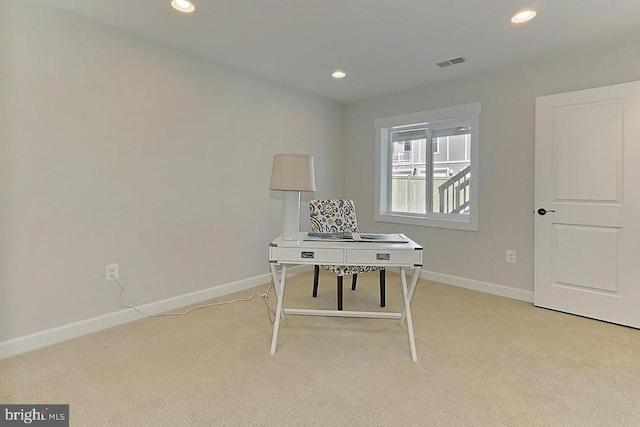 unfurnished office featuring light colored carpet