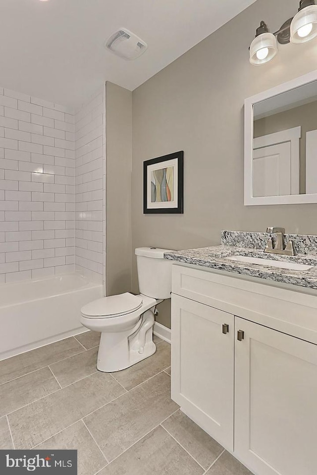 full bathroom featuring tile patterned flooring, vanity, toilet, and tiled shower / bath combo