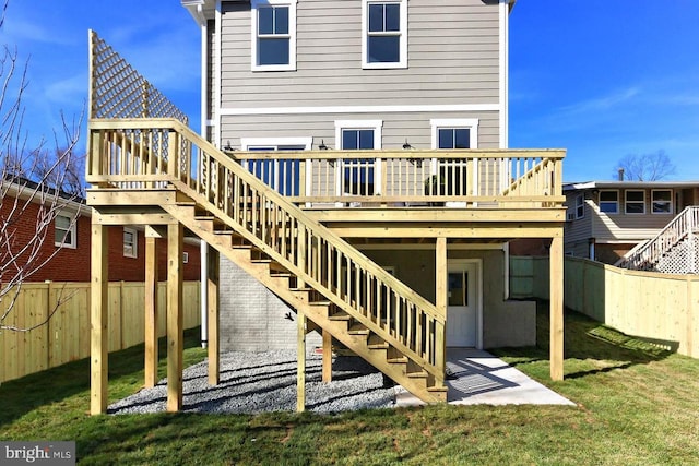 back of property featuring a yard and a deck