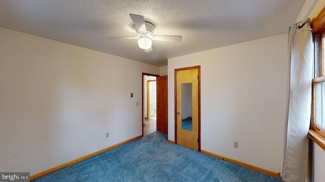 unfurnished bedroom with carpet flooring, ceiling fan, and a textured ceiling