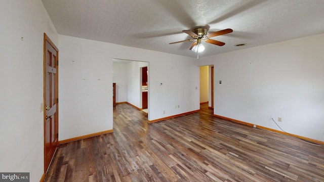 unfurnished room featuring dark hardwood / wood-style floors, ceiling fan, and a textured ceiling