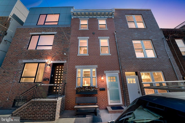 view of back house at dusk