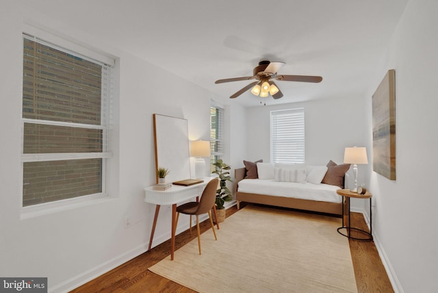 living area with hardwood / wood-style flooring and ceiling fan