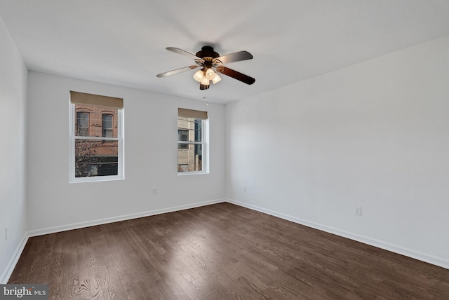 spare room featuring ceiling fan and dark wood-type flooring