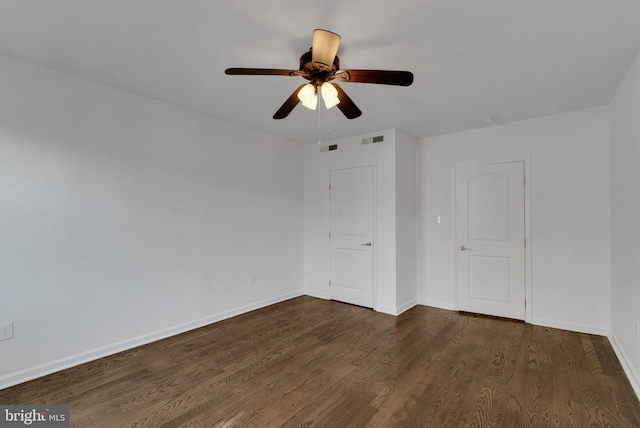 unfurnished room featuring ceiling fan and dark wood-type flooring