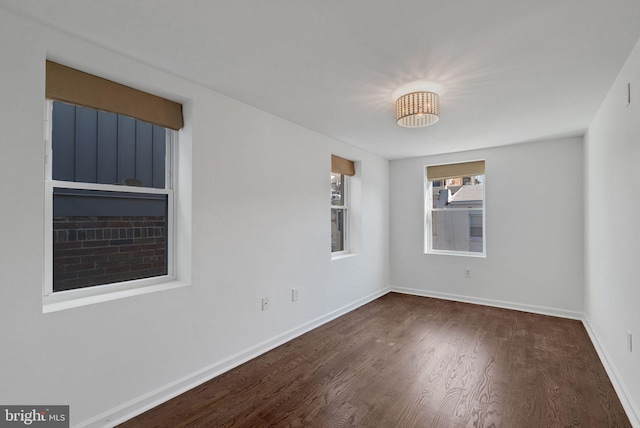 spare room featuring dark wood-type flooring