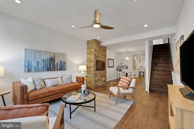 living room with ceiling fan, dark hardwood / wood-style flooring, and a fireplace