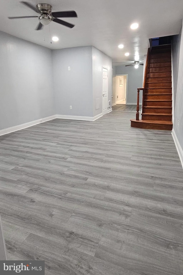 basement with ceiling fan and light hardwood / wood-style flooring