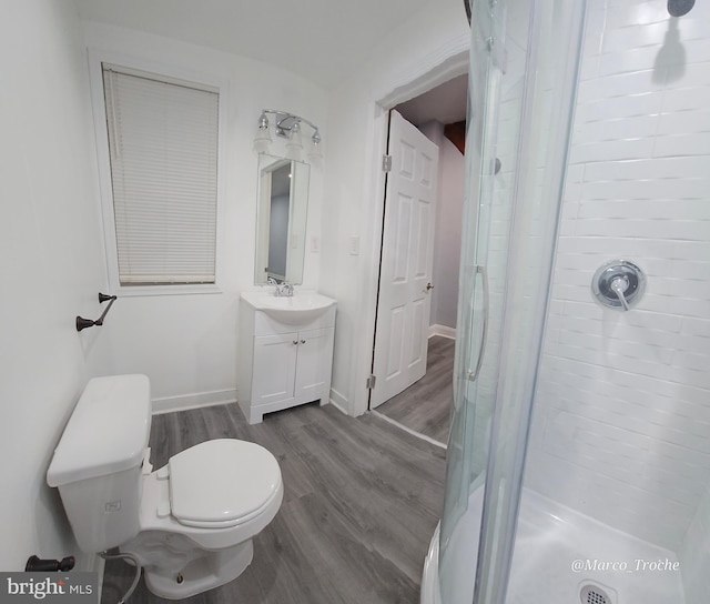 bathroom with vanity, toilet, wood-type flooring, and walk in shower