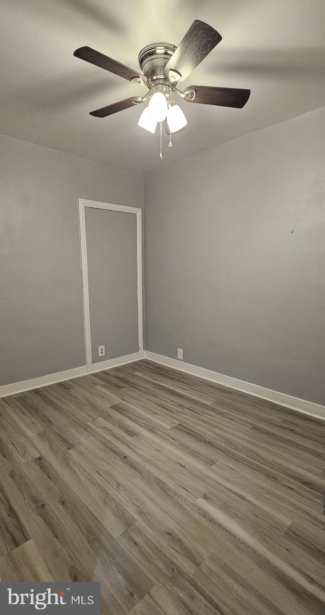 spare room featuring ceiling fan and hardwood / wood-style flooring