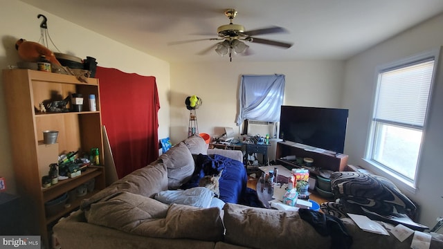 living area featuring cooling unit and ceiling fan