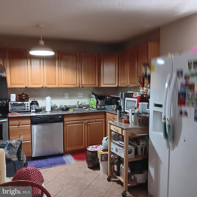 kitchen featuring a textured ceiling, sink, dishwasher, white fridge with ice dispenser, and light tile patterned flooring