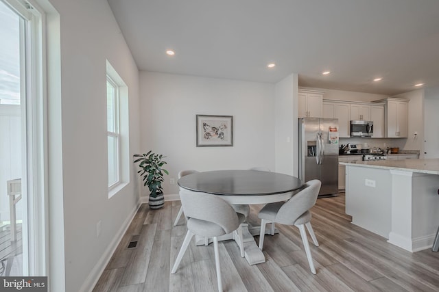 dining room featuring light hardwood / wood-style floors and plenty of natural light