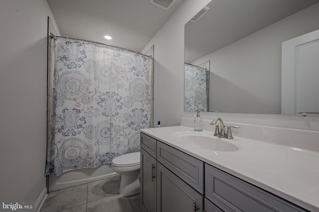 full bathroom with tile patterned floors, vanity, shower / tub combo, and toilet