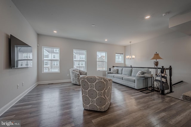 living room with a chandelier and dark hardwood / wood-style flooring