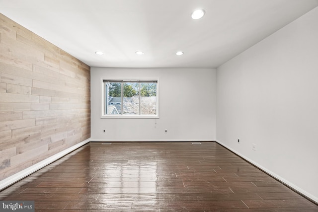 spare room featuring dark wood-type flooring