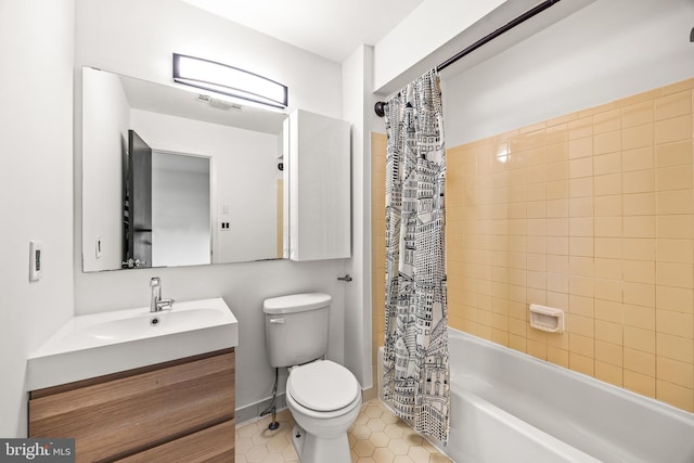 full bathroom featuring tile patterned flooring, shower / tub combo with curtain, vanity, and toilet