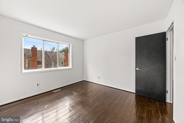 empty room featuring dark wood-type flooring