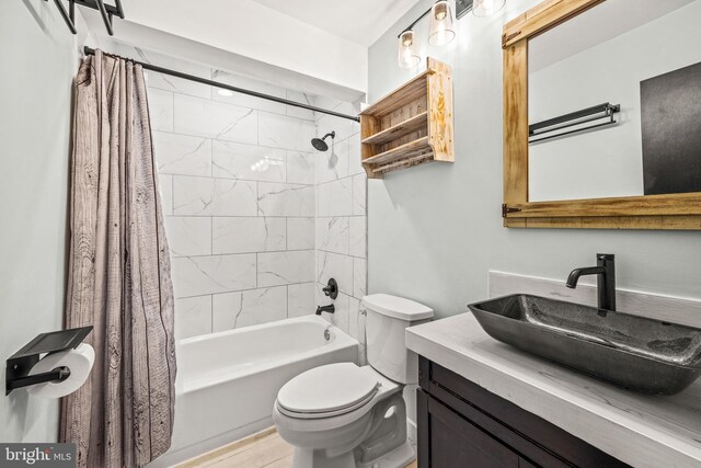 full bathroom with vanity, wood-type flooring, shower / tub combo, and toilet