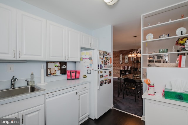 kitchen featuring pendant lighting, white appliances, white cabinetry, and sink