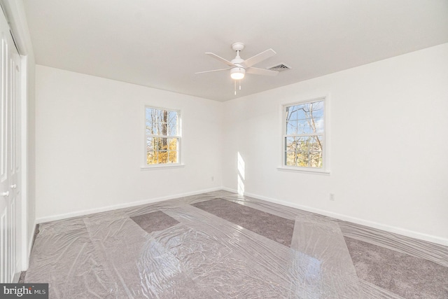 empty room featuring light carpet and ceiling fan