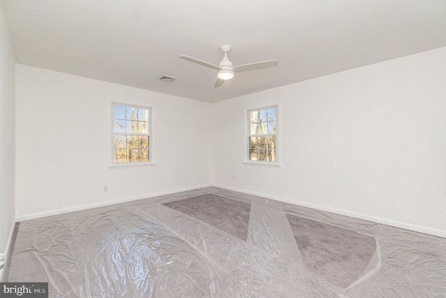 unfurnished room featuring light colored carpet and ceiling fan