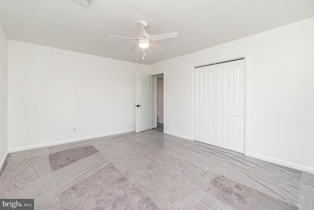 unfurnished bedroom featuring a closet, ceiling fan, and light colored carpet