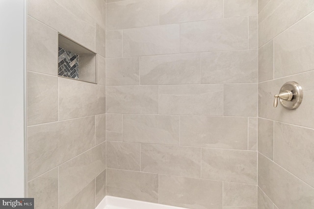 bathroom with tiled shower