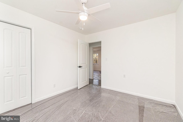 unfurnished bedroom featuring ceiling fan, a closet, and light hardwood / wood-style flooring