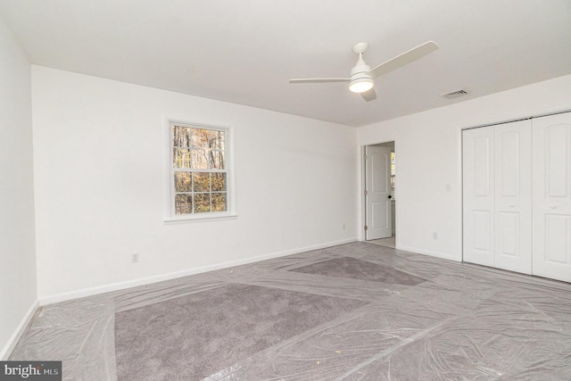 unfurnished bedroom with a closet, light colored carpet, and ceiling fan