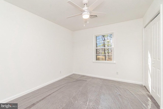 unfurnished bedroom with ceiling fan, a closet, and light carpet