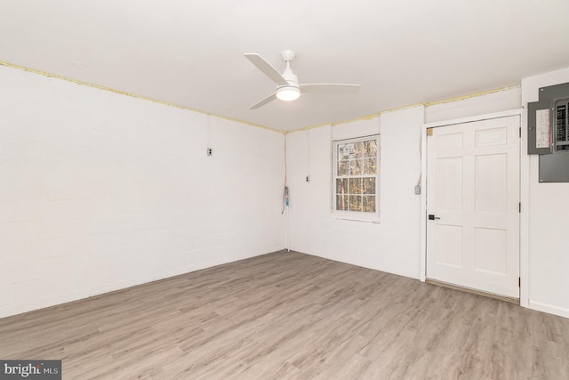 spare room featuring ceiling fan, light hardwood / wood-style floors, and electric panel