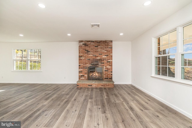 unfurnished living room with a fireplace and hardwood / wood-style floors