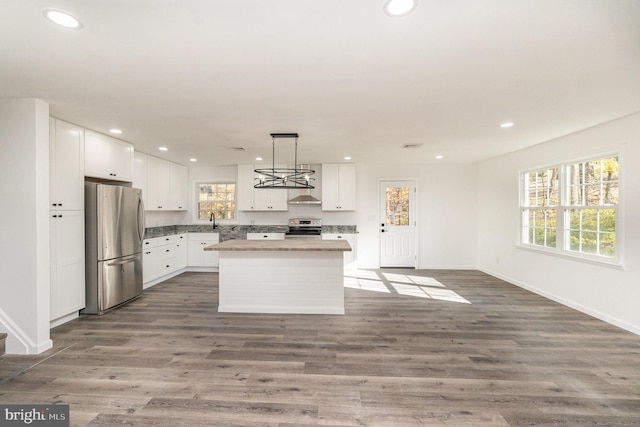 kitchen with a healthy amount of sunlight, white cabinetry, and stainless steel appliances