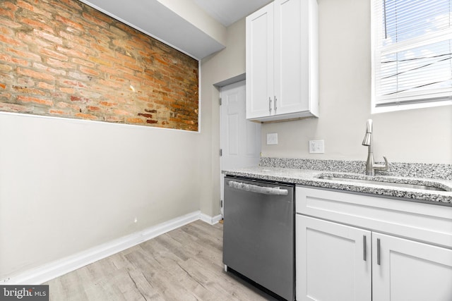 kitchen featuring dishwasher, light hardwood / wood-style floors, white cabinetry, and sink