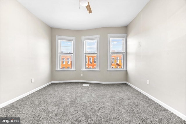 empty room featuring carpet floors and ceiling fan