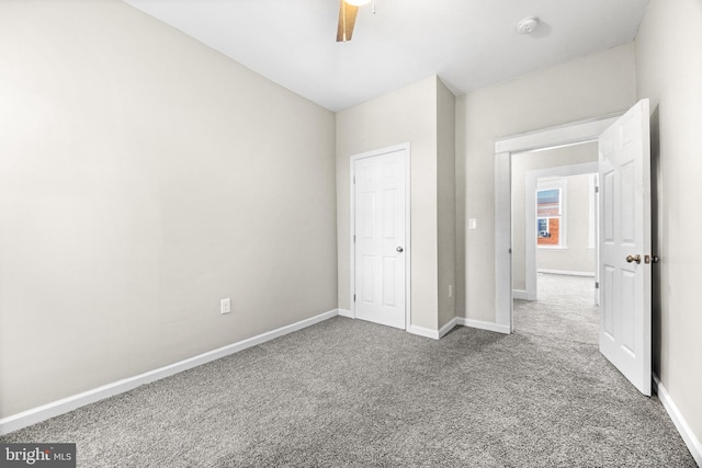 unfurnished bedroom featuring carpet flooring, a closet, and ceiling fan