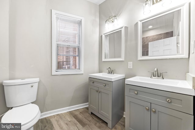 bathroom featuring vanity, wood-type flooring, and toilet