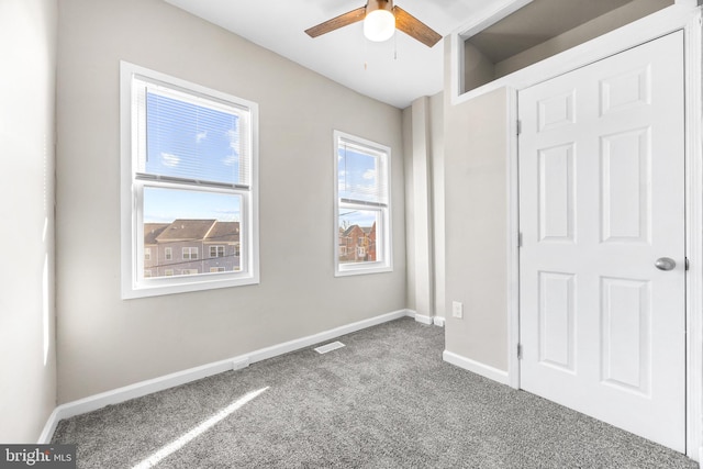 unfurnished bedroom featuring ceiling fan and carpet