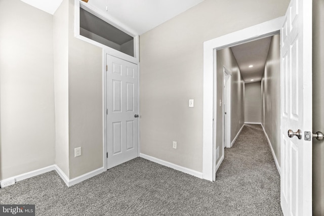 corridor with dark colored carpet