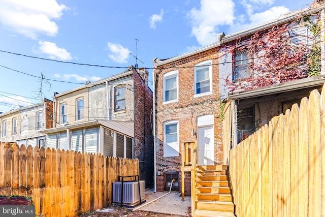 rear view of property featuring central air condition unit