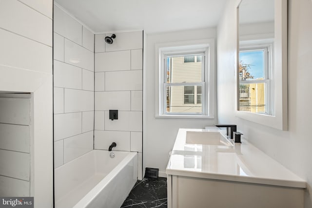 bathroom featuring vanity, tiled shower / bath, and a wealth of natural light