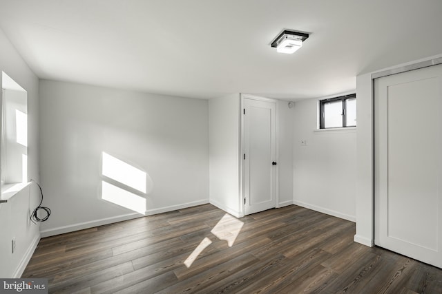 empty room with dark hardwood / wood-style floors