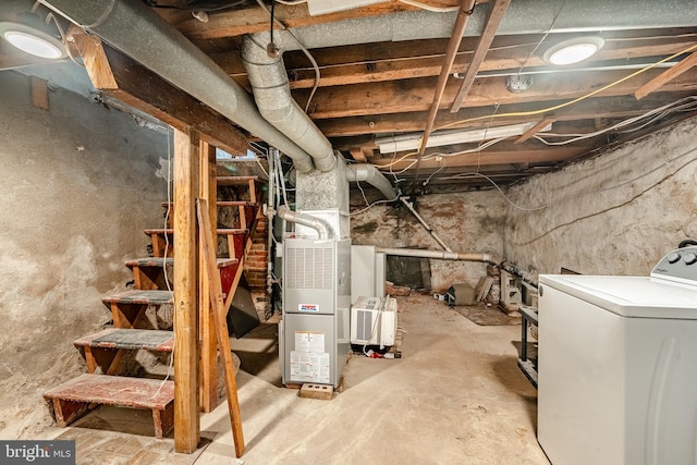 basement featuring washer / dryer and heating unit