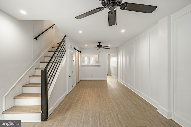 interior space with a barn door and light wood-type flooring