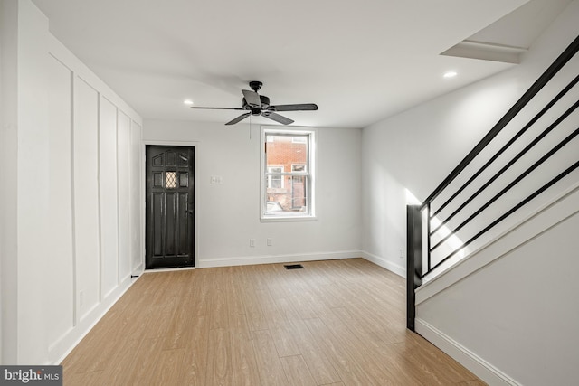 foyer with ceiling fan and light wood-type flooring