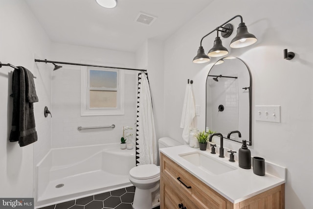 bathroom with vanity, a shower with shower curtain, and toilet