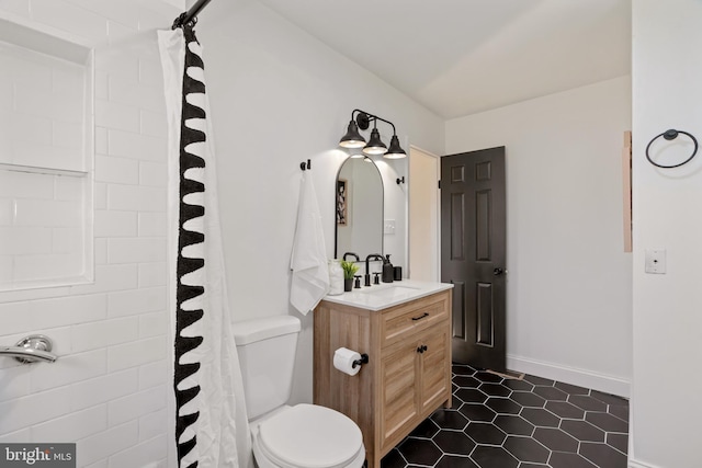 bathroom with tile patterned floors, vanity, and toilet